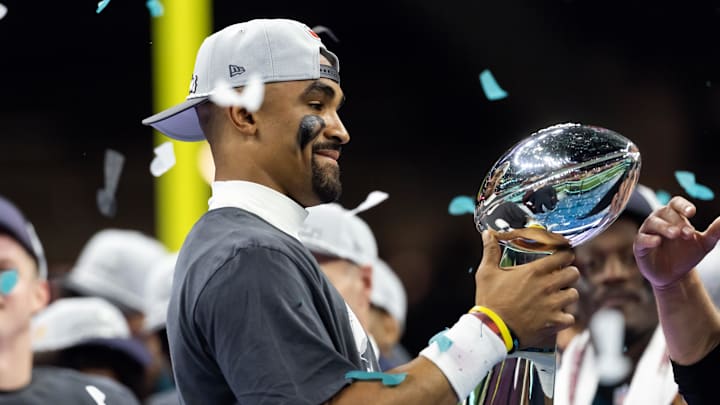 Philadelphia Eagles quarterback Jalen Hurts celebrates with the Vince Lombardi Trophy after defeating the Kansas City Chiefs during Super Bowl LIX.
