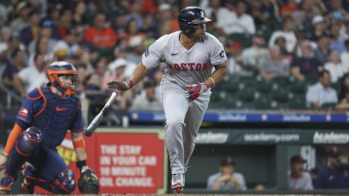 Aug 19, 2024; Houston, Texas, USA; Boston Red Sox third baseman Rafael Devers (11) hits a single during the first inning against the Houston Astros at Minute Maid Park.
