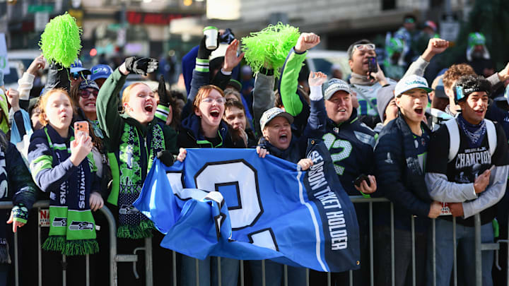 Fans cheer before the start of the Seattle Seahawks Super Bowl LX parade.