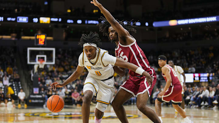 Missouri Tigers guard Anthony Robinson II (0) drives on a defender, in a game versus the Oklahoma Sooners this season.