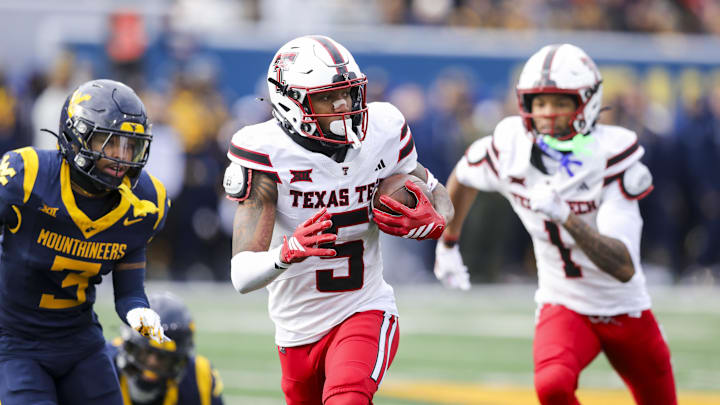 Nov 29, 2025; Morgantown, West Virginia, USA; Texas Tech Red Raiders wide receiver Caleb Douglas (5) makes a catch and runs for extra yards during the second quarter against the West Virginia Mountaineers at Milan Puskar Stadium. Mandatory Credit: Ben Queen-Imagn Images Nov 29, 2025; Morgantown, West Virginia, USA; Texas Tech Red Raiders wide receiver Caleb Douglas (5) makes a catch and runs for extra yards during the second quarter against the West Virginia Mountaineers at Milan Puskar Stadium. Mandatory Credit: Ben Queen-Imagn Images
