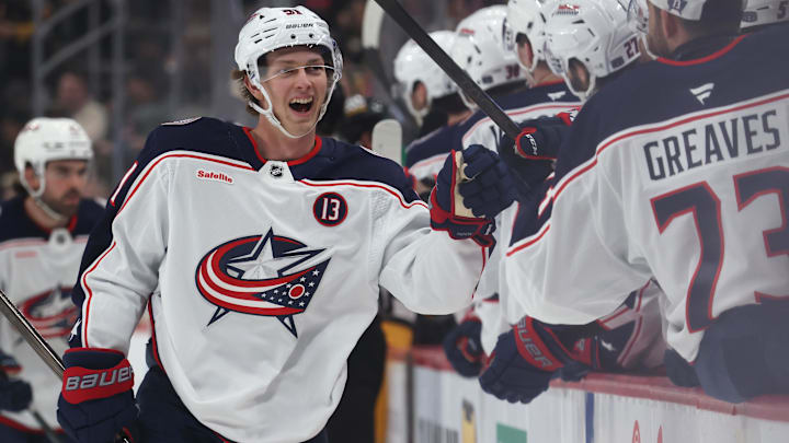 Mar 21, 2025; Pittsburgh, Pennsylvania, USA;  Columbus Blue Jackets center Kent Johnson (91) celebrates with the  Blue Jackets bench after scoring a goal against the Pittsburgh Penguins during the third period at PPG Paints Arena. Mandatory Credit: Charles LeClaire-Imagn Images
