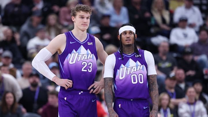 Dec 28, 2024; Salt Lake City, Utah, USA; Utah Jazz forward Lauri Markkanen (23) and guard Jordan Clarkson (00) watch the Philadelphia 76ers shoot free throws during the fourth quarter at Delta Center. Mandatory Credit: Rob Gray-Imagn Images