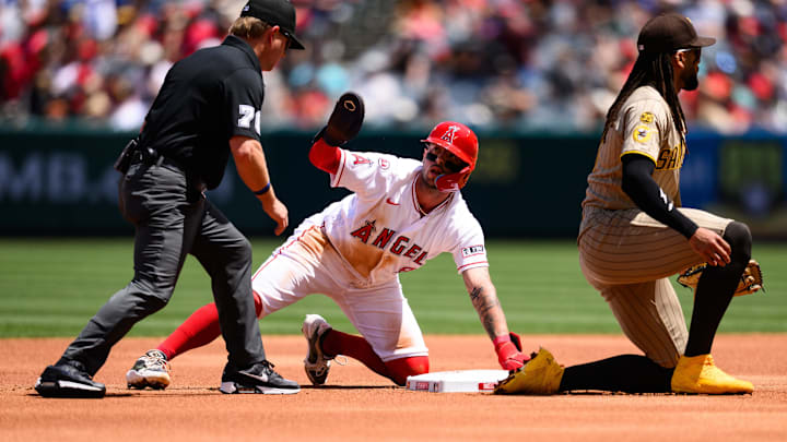 Apr 19, 2026; Anaheim, California, USA; Los Angeles Angels shortstop Zach Neto (9) safely steals second base past San Diego Padres second baseman Fernando Tatis Jr. (23) during the first inning at Angel Stadium. Mandatory Credit: William Liang-Imagn Images