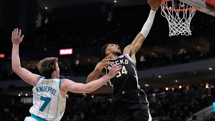Nov 14, 2025; Milwaukee, Wisconsin, USA;  Milwaukee Bucks forward Giannis Antetokounmpo (34) dunks as Charlotte Hornets guard Kon Knueppel (7) defends during overtime at Fiserv Forum. Mandatory Credit: Jeff Hanisch-Imagn Images