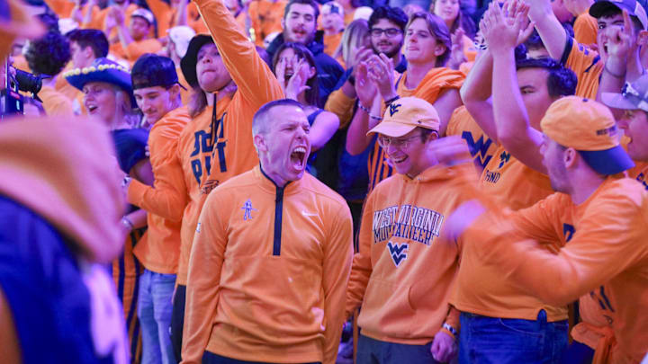 Nov 13, 2025; Morgantown, West Virginia, USA; West Virginia Mountaineers head coach Ross Hodge sings “Country Roads” with students after defeating the Pittsburgh Panthers at WVU Coliseum. Mandatory Credit: Ben Queen-Imagn Images Nov 13, 2025; Morgantown, West Virginia, USA; West Virginia Mountaineers head coach Ross Hodge sings “Country Roads” with students after defeating the Pittsburgh Panthers at WVU Coliseum. Mandatory Credit: Ben Queen-Imagn Images