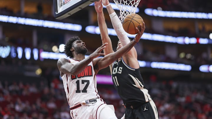 Feb 25, 2025; Houston, Texas, USA; Houston Rockets forward Tari Eason (17) attempts to score a basket as Milwaukee Bucks center Brook Lopez (11) defends during the first quarter at Toyota Center. Mandatory Credit: Troy Taormina-Imagn Images