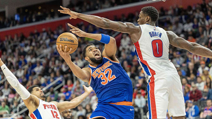 Apr 27, 2025; Detroit, Michigan, USA; New York Knicks center Karl-Anthony Towns (32) drives to the basket between Detroit Pistons center Jalen Duren (0) and forward Tobias Harris (12) : David Reginek-Imagn Images