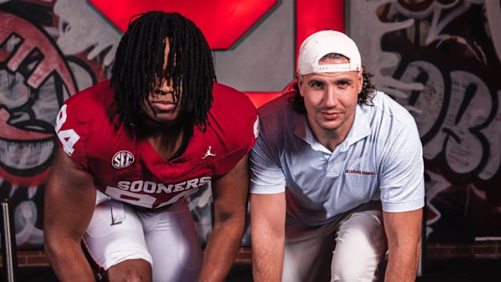New Oklahoma defensive lineman Kenny Ozowalu and defensive ends coach Miguel Chavis New Oklahoma defensive lineman Kenny Ozowalu and defensive ends coach Miguel Chavis