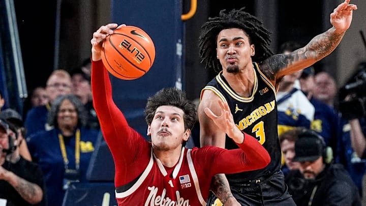 Michigan guard Elliot Cadeau (3) and Nebraska forward Berke Buyuktuncel (9) battle for the ball during the second half at Crisler Center in Ann Arbor on Tuesday, Jan. 27, 2026.
