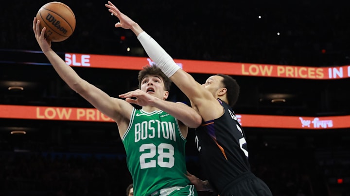 Feb 24, 2026; Phoenix, Arizona, USA; Boston Celtics guard Hugo Gonzalez (28) drives to the basket against Phoenix Suns guard Amir Coffey in the second half at Mortgage Matchup Center. Mandatory Credit: Mark J. Rebilas-Imagn Images Feb 24, 2026; Phoenix, Arizona, USA; Boston Celtics guard Hugo Gonzalez (28) drives to the basket against Phoenix Suns guard Amir Coffey in the second half at Mortgage Matchup Center. Mandatory Credit: Mark J. Rebilas-Imagn Images