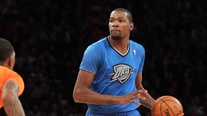 Dec 25, 2013; New York, NY, USA; Oklahoma City Thunder small forward Kevin Durant (35) controls the ball against New York Knicks shooting guard J.R. Smith (8) during the second quarter of a game at Madison Square Garden. Mandatory Credit: Brad Penner-Imagn Images