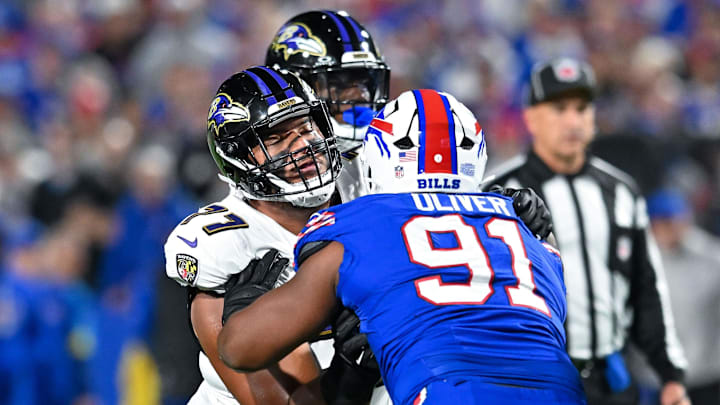 Sep 7, 2025; Orchard Park, New York, USA; Baltimore Ravens guard Daniel Faalele (77) blocks Buffalo Bills defensive tackle Ed Oliver (91) in the first quarter 
