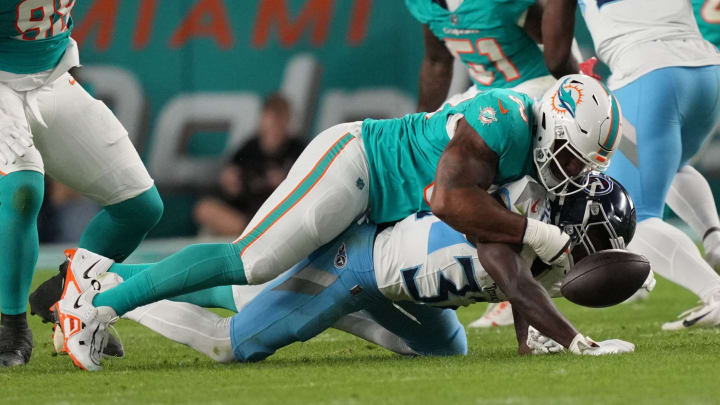 Miami Dolphins defensive tackle Da'Shawn Hand (93) forces a fumble by Tennessee Titans running back Tyjae Spears (32) during the first half of the Monday night game at Hard Rock Stadium last December. Miami Dolphins defensive tackle Da'Shawn Hand (93) forces a fumble by Tennessee Titans running back Tyjae Spears (32) during the first half of the Monday night game at Hard Rock Stadium last December.