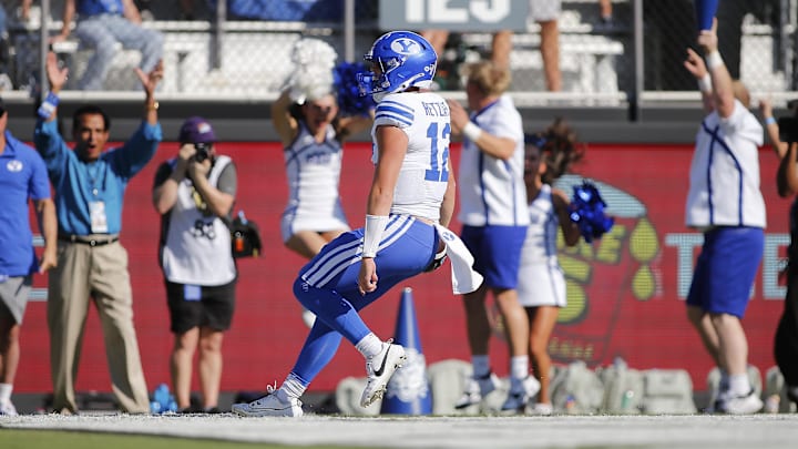 Oct 26, 2024; Orlando, Florida, USA; Brigham Young Cougars quarterback Jake Retzlaff (12) runs for a touchdown against the Central Florida Knights at FBC Mortgage Stadium. Mandatory Credit: Russell Lansford-Imagn Images