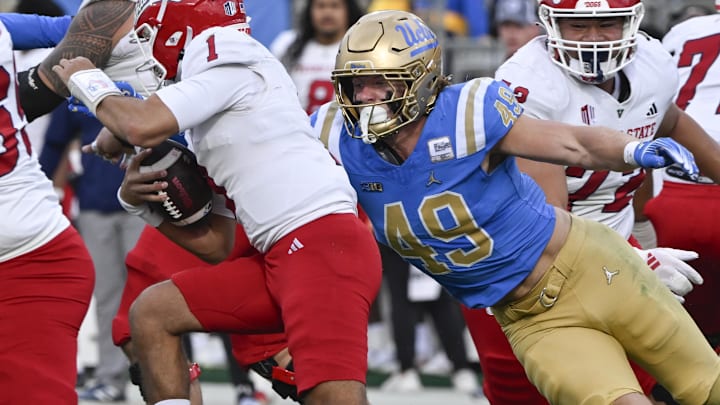 Nov 30, 2024; Pasadena, California, USA; UCLA Bruins linebacker Carson Schwesinger (49) sacks Fresno State Bulldogs quarterback Mikey Keene (1) during the second quarter at Rose Bowl. Mandatory Credit: Robert Hanashiro-Imagn Images