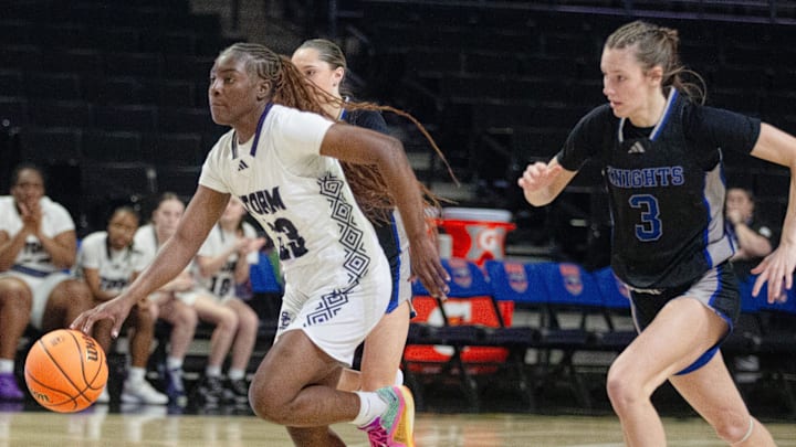 Stuart Cramer's Oshauna Holland dribbles up the court during the NCHSAA 3A West final at Lawrence Joel Veterans Coliseum in Winston-Salem. Cramer won 62-38 to advance to the NCHSAA 3A final.