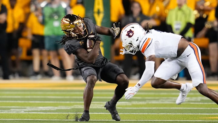 Aug 29, 2025; Waco, Texas, USA; Baylor Bears wide receiver Kole Wilson (2) makes a catch as Auburn Tigers safety Champ Anthony (1) defends during the first half at McLane Stadium. Mandatory Credit: Chris Jones-Imagn Images