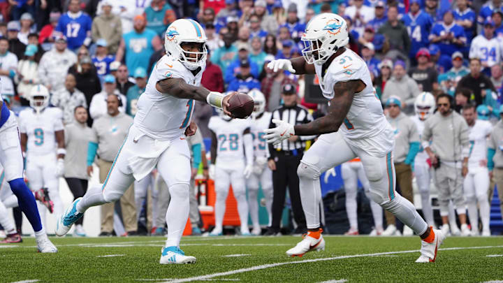 Nov 3, 2024; Orchard Park, New York, USA; Miami Dolphins quarterback Tua Tagovailoa (1) hands off the ball to Miami Dolphins running back Raheem Mostert (31) during the second half against the Buffalo Bills at Highmark Stadium.