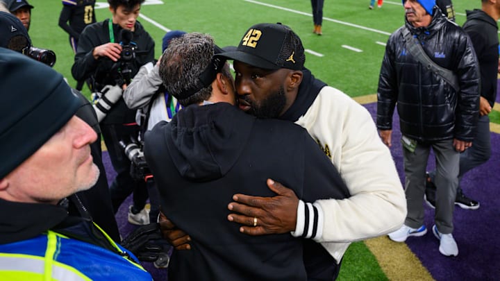 Nov 15, 2024; Seattle, Washington, USA; Washington Huskies head coach Jedd Fisch and UCLA Bruins head coach DeShaun Foster greet each other after the game at Alaska Airlines Field at Husky Stadium. Mandatory Credit: Steven Bisig-Imagn Images