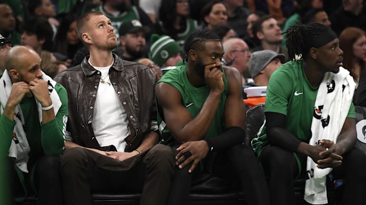 Jan 27, 2024; Boston, Massachusetts, USA;  Boston Celtics center Kristaps Porzingis (8) guard Jaylen Brown (7) and guard Jrue Holiday (4) on the bench during the second half against the LA Clippers at TD Garden. Mandatory Credit: Bob DeChiara-Imagn Images