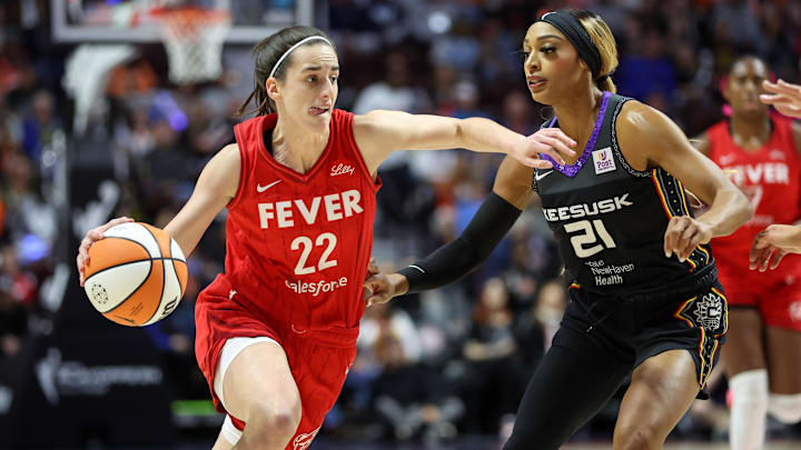 Sep 25, 2024; Uncasville, Connecticut, USA; Indiana Fever guard Caitlin Clark (22) drives to the basket defended by Connecticut Sun guard DiJonai Carrington (21) during the first half during game two of the first round of the 2024 WNBA Playoffs at Mohegan Sun Arena. Mandatory Credit: Paul Rutherford-Imagn Images Sep 25, 2024; Uncasville, Connecticut, USA; Indiana Fever guard Caitlin Clark (22) drives to the basket defended by Connecticut Sun guard DiJonai Carrington (21) during the first half during game two of the first round of the 2024 WNBA Playoffs at Mohegan Sun Arena. Mandatory Credit: Paul Rutherford-Imagn Images