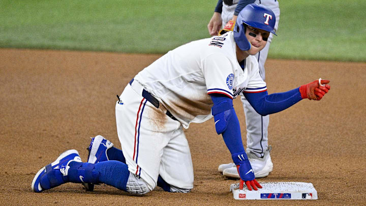 Texas Rangers designated hitter Joc Pederson points to the dugout after he slid into second base.
