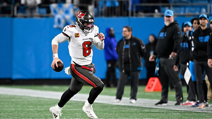 Dec 1, 2024; Charlotte, North Carolina, USA; Tampa Bay Buccaneers quarterback Baker Mayfield (6) runs for a firts down in overtime at Bank of America Stadium. Mandatory Credit: Bob Donnan-Imagn Images
