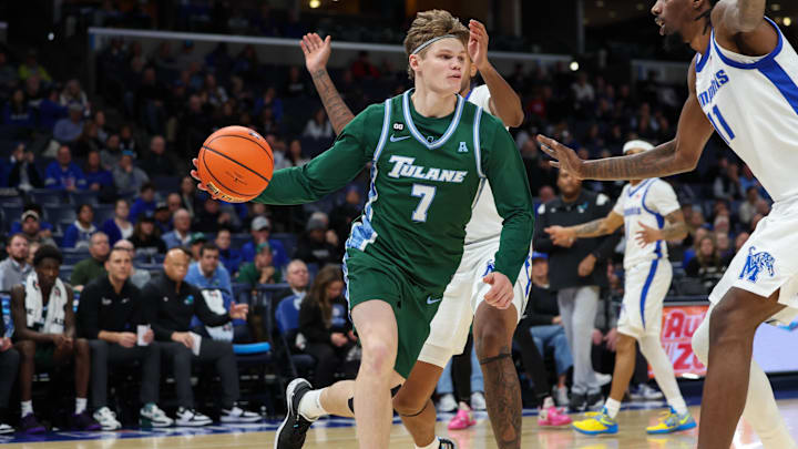 Feb 1, 2026; Memphis, Tennessee, USA; Tulane Green Wave guard Rowan Brumbaugh (7) drives with the ball against Memphis Tigers forward Aaron Bradshaw (11) during the second half at FedExForum. Mandatory Credit: Wesley Hale-Imagn Images