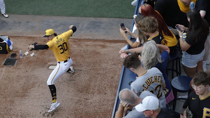 Fans look on as Pittsburgh Pirates starting pitcher Paul Skenes (30) warms up in the bullpen before pitching against the Seattle Mariners at PNC Park. 