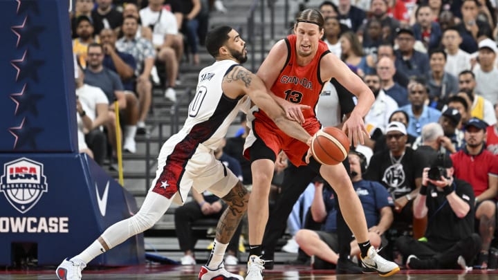 Jul 10, 2024; Las Vegas, Nevada, USA; USA forward Jayson Tatum (10) knocks the ball away from Canada forward Kelly Olynyk (13) in the first quarter during the USA Basketball Showcase at T-Mobile Arena. Mandatory Credit: Candice Ward-USA TODAY Sports Jul 10, 2024; Las Vegas, Nevada, USA; USA forward Jayson Tatum (10) knocks the ball away from Canada forward Kelly Olynyk (13) in the first quarter during the USA Basketball Showcase at T-Mobile Arena. Mandatory Credit: Candice Ward-USA TODAY Sports
