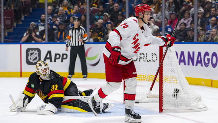 Oct 28, 2024; Vancouver, British Columbia, CAN; Carolina Hurricanes forward Sebastian Aho (20) scores the game winning goal on Vancouver Canucks goalie Kevin Lankinen (32) in overtime at Rogers Arena. Mandatory Credit: Bob Frid-Imagn Images