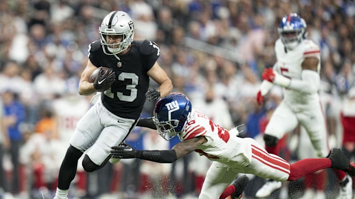 November 5, 2023; Paradise, Nevada, USA; Las Vegas Raiders wide receiver Hunter Renfrow (13) is tackled by New York Giants cornerback Cor'Dale Flott (28) during the second quarter at Allegiant Stadium. Mandatory Credit: Kyle Terada-Imagn Images