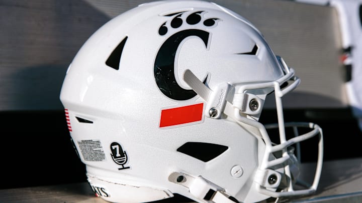 Oct 18, 2025; Stillwater, Oklahoma, USA; Cincinnati Bearcats helmet sits on the bench prior to the game against the Oklahoma State Cowboys at Boone Pickens Stadium. Mandatory Credit: William Purnell-Imagn Images