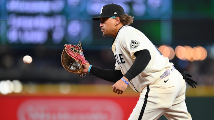Josh Naylor (12) fields a ball hit by Cleveland Guardians center fielder Steven Kwan (38) 