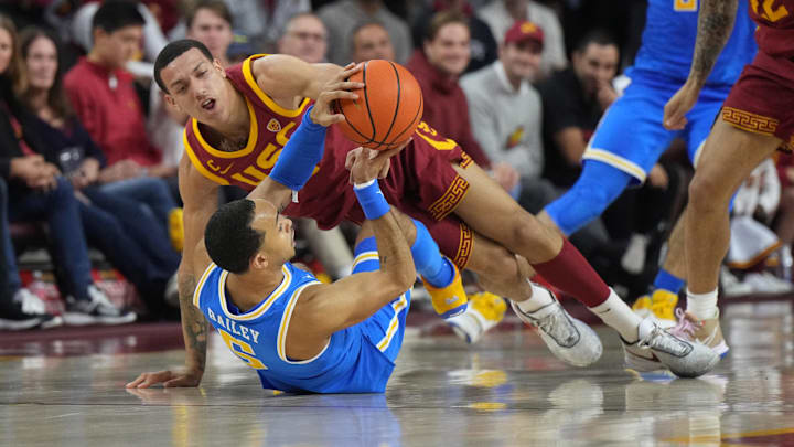Jan 26, 2023; Los Angeles, California, USA; Southern California Trojans forward Kobe Johnson (0) and UCLA Bruins guard Amari Bailey (5) battle for the ball in the second half at Galen Center. Mandatory Credit: Kirby Lee-Imagn Images