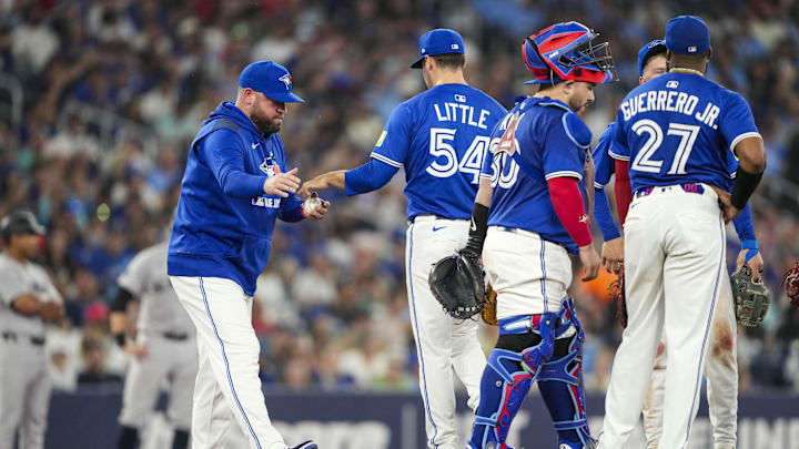 Jul 2, 2025; Toronto, Ontario, CAN; Toronto Blue Jays manager John Schneider (14) relieves Toronto Blue Jays pitcher Brendon Little (54) during the sixth inning against the New York Yankees at Rogers Centre. 