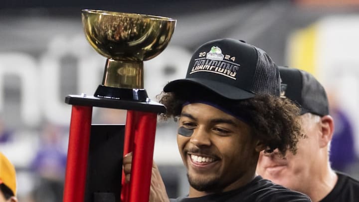 Dec 26, 2024; Phoenix, AZ, USA; Kansas State Wildcats running back Dylan Edwards (3) celebrates with the offensive MVP trophy after defeating the Rutgers Scarlet Knights during the Rate Bowl at Chase Field. Mandatory Credit: Mark J. Rebilas-Imagn Images Dec 26, 2024; Phoenix, AZ, USA; Kansas State Wildcats running back Dylan Edwards (3) celebrates with the offensive MVP trophy after defeating the Rutgers Scarlet Knights during the Rate Bowl at Chase Field. Mandatory Credit: Mark J. Rebilas-Imagn Images