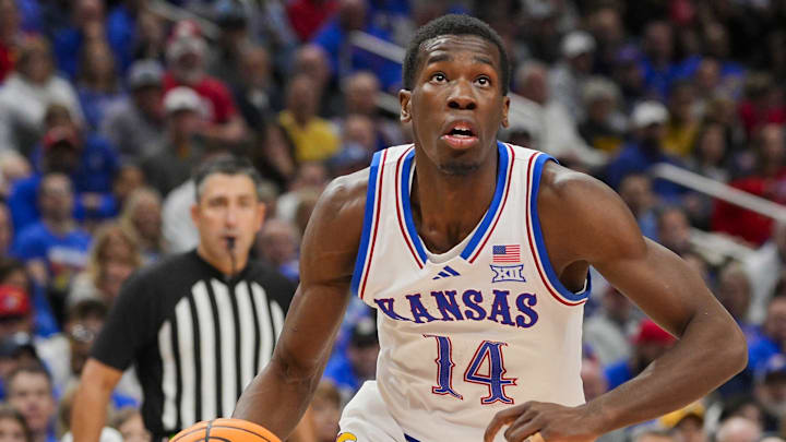 Dec 7, 2025; Kansas City, Missouri, USA; Kansas Jayhawks guard Melvin Council Jr. (14) drives against during the first half against the Missouri Tigers at T-Mobile Center. Mandatory Credit: Jay Biggerstaff-Imagn Images