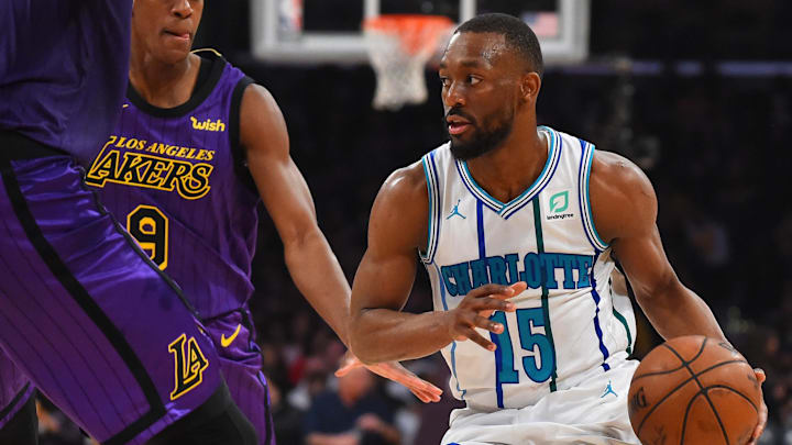 Mar 29, 2019; Los Angeles, CA, USA; Charlotte Hornets guard Kemba Walker (15) controls the ball against Los Angeles Lakers guard Rajon Rondo (9) and center JaVale McGee (7) in the first half of the game at Staples Center. Mandatory Credit: Jayne Kamin-Oncea-Imagn Images