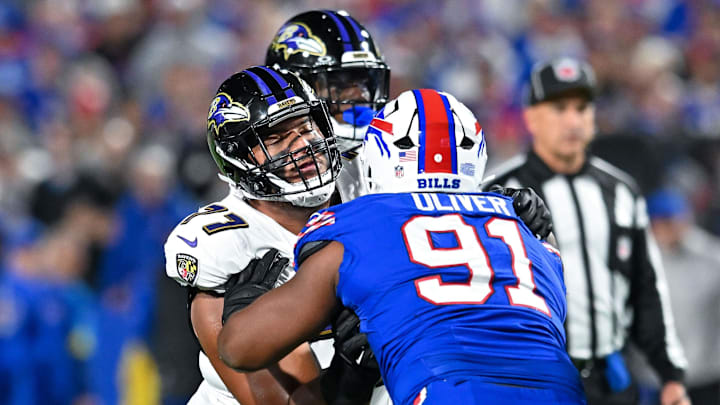 Sep 7, 2025; Orchard Park, New York, USA; Baltimore Ravens guard Daniel Faalele (77) blocks Buffalo Bills defensive tackle Ed Oliver (91).