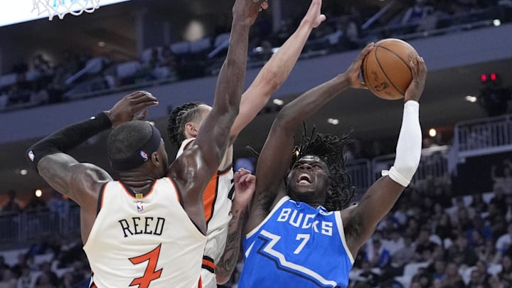 Apr 13, 2025; Milwaukee, Wisconsin, USA; Milwaukee Bucks forward Chris Livingston (7) puts up a shot against Detroit Pistons forward Lindy Waters III (43) and Detroit Pistons forward Paul Reed (7) in the first half at American Family Field. Mandatory Credit: Michael McLoone-Imagn Images