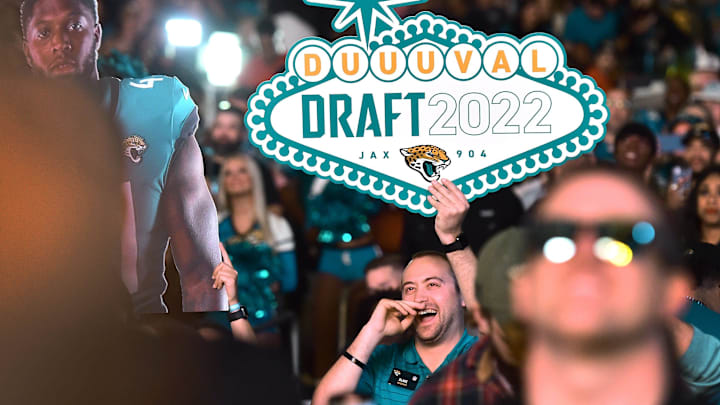 A Jaguars fan in the crowd holds a DUUUVAL Draft sign during the team's NFL Draft party Thursday.
