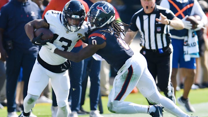 Houston Texans cornerback Shaquill Griffin (0) pushes Jacksonville Jaguars wide receiver Christian Kirk (13) out of bounds on a fourth quarter pass play for a first down. The Jacksonville Jaguars hosted the Tennessee Titans at EverBank Stadium in Jacksonville, Fla. Sunday, September 24, 2023. The Jaguars trailed 17 to 0 at the end of the first half and lost with a final score of 37-17. [Bob Self/Florida Times-Union]