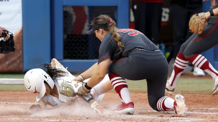 Texas infielder Alyssa Washington (11) tags home under Stanford's Ava Gall (51) to score a run in the seventh inning of a Women's College World Series semifinal softball game between the Stanford Cardinal and the Texas Longhorns at Devon Park in Oklahoma City, Monday, June 3, 2024. Texas won 1-0. Texas infielder Alyssa Washington (11) tags home under Stanford's Ava Gall (51) to score a run in the seventh inning of a Women's College World Series semifinal softball game between the Stanford Cardinal and the Texas Longhorns at Devon Park in Oklahoma City, Monday, June 3, 2024. Texas won 1-0.