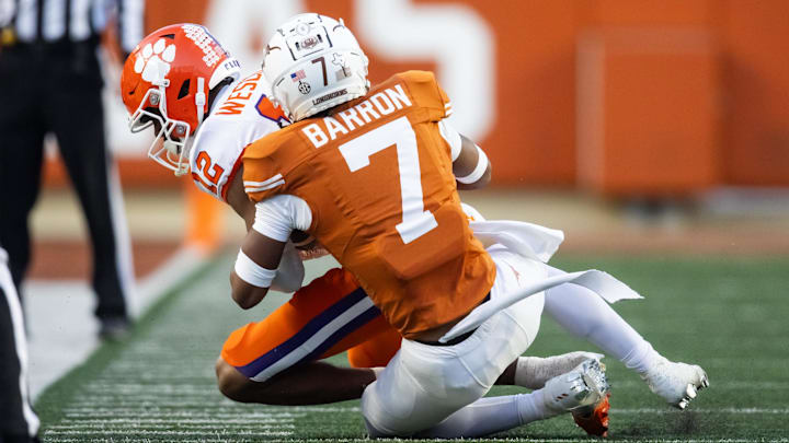 Dec 21, 2024; Austin, Texas, USA; Texas Longhorns defensive back Jahdae Barron (7) tackles Clemson Tigers wide receiver Bryant Wesco Jr. (12) during the CFP National playoff first round at Darrell K Royal-Texas Memorial Stadium. Mandatory Credit: Mark J. Rebilas-Imagn Images