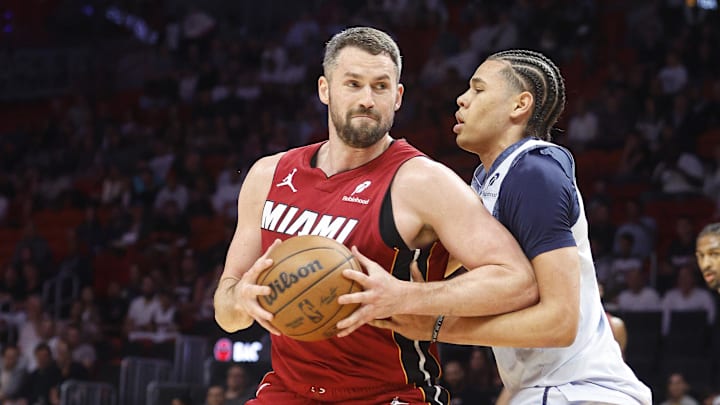 Mar 3, 2025; Miami, Florida, USA;  Washington Wizards forward Kyshawn George (18)defends Miami Heat forward Kevin Love (42) during the first half at Kaseya Center. Mandatory Credit: Rhona Wise-Imagn Images