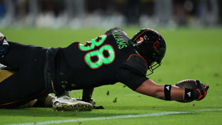Oct 7, 2023; Miami Gardens, Florida, USA; Miami Hurricanes tight end Riley Williams (88) reaches for the goal line to score a touchdown against the Georgia Tech Yellow Jackets in the second half at Hard Rock Stadium. Mandatory Credit: Jasen Vinlove-USA TODAY Sports