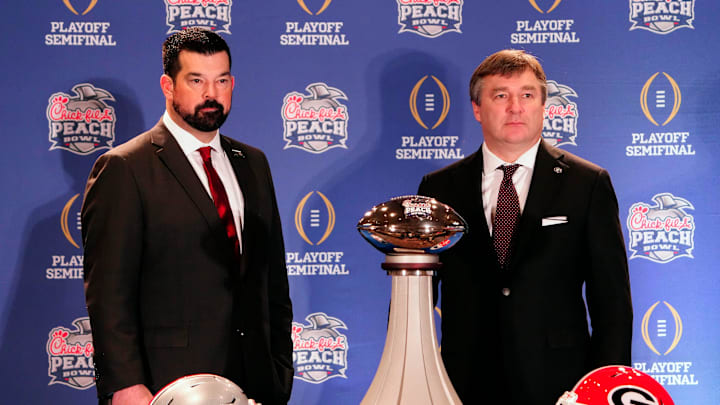 Dec 30, 2022; Atlanta, GA, USA; Ohio State Buckeyes head coach Ryan Day and Georgia Bulldogs head coach Kirby Smart pose for a photo during the coaches Peach Bowl press conference at the Westin Peachtree Plaza.