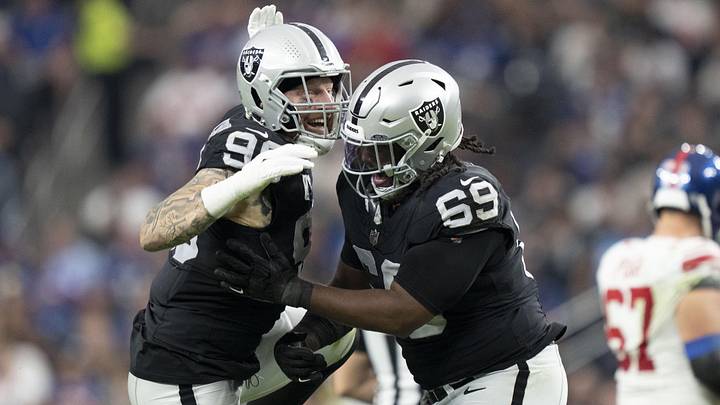 November 5, 2023; Paradise, Nevada, USA; Las Vegas Raiders defensive end Maxx Crosby (98) and defensive tackle Adam Butler (69) celebrate after sacking New York Giants quarterback Tommy DeVito (not pictured) during the third quarter at Allegiant Stadium. Mandatory Credit: Kyle Terada-USA TODAY Sports